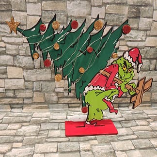 Grinch holding a tree